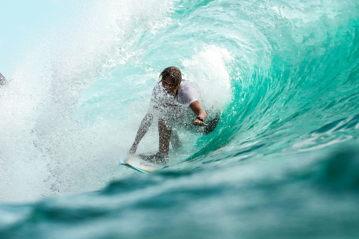 Surfer riding wave with SWAX grip
